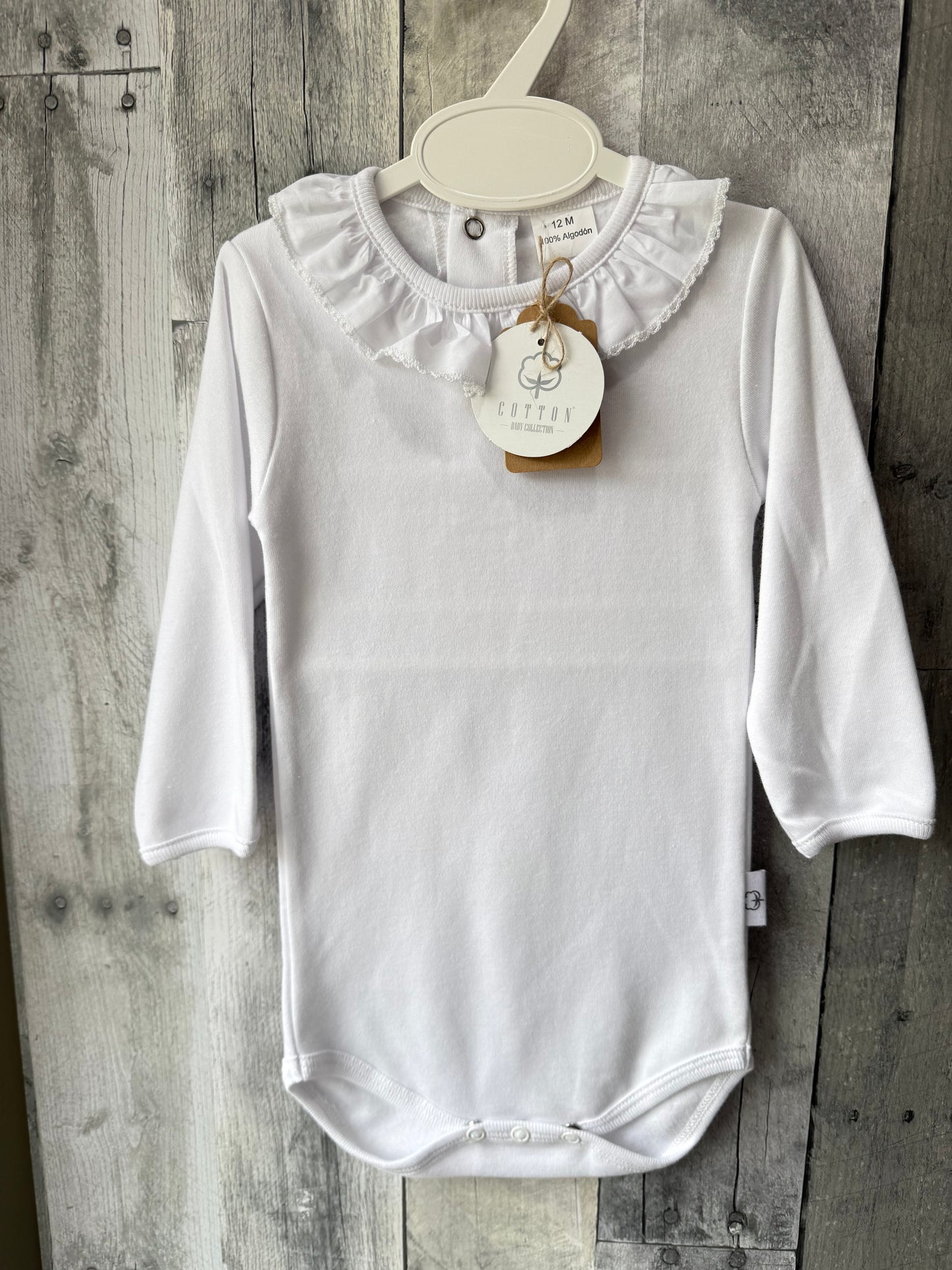 White body suit with gathered, detailed collar