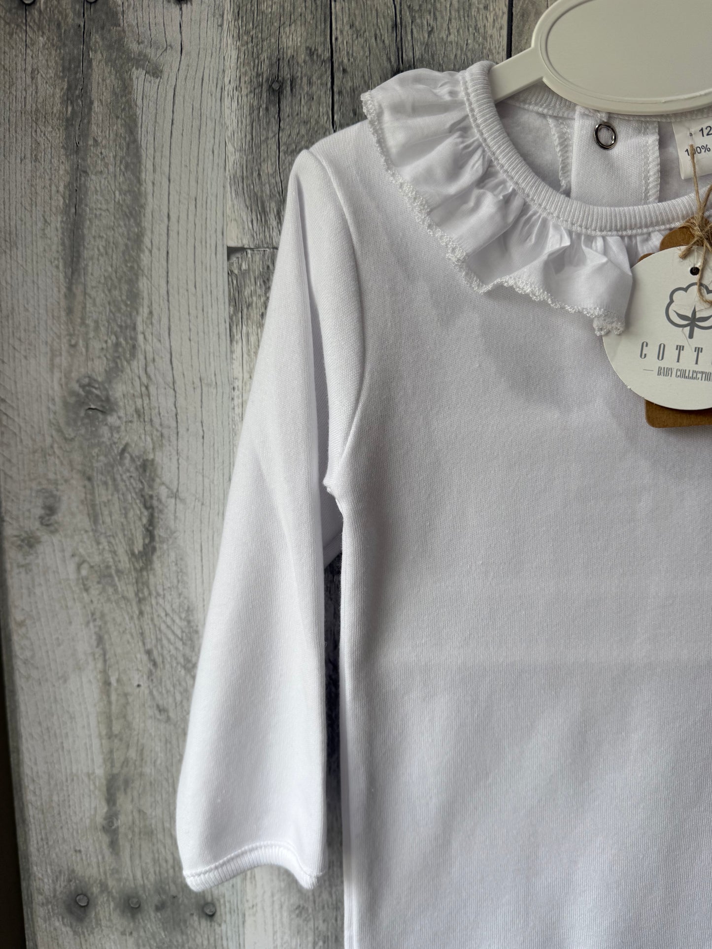 White body suit with gathered, detailed collar